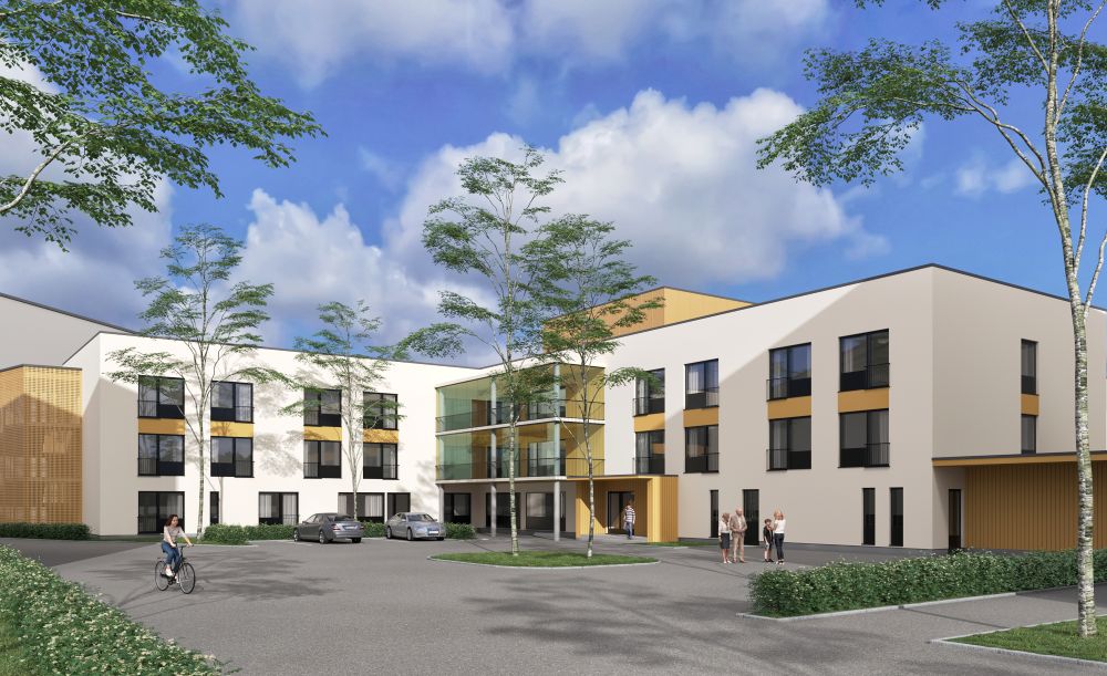 Hoitaja työntää pyörätuolissa istuvaa asukasta