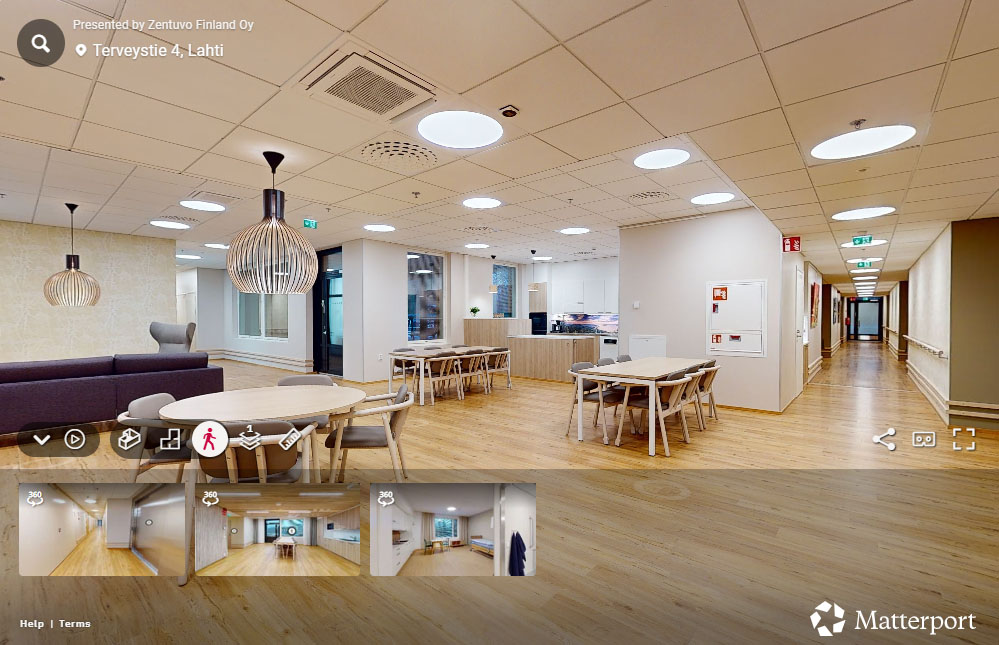 Kuvakaappaus Attendo Salpakankaan virtuaaliesittelystä, jossa näkyy ruokailutila pöytineen ja tuolineen